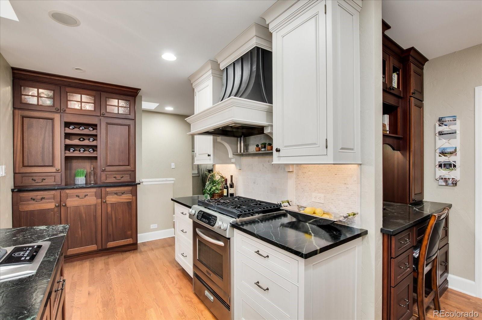 5225 Ridge Trail Bow Mar, CO 80123 - Photo 29 of 40 a kitchen with stainless steel appliances a stove a sink and a refrigerator