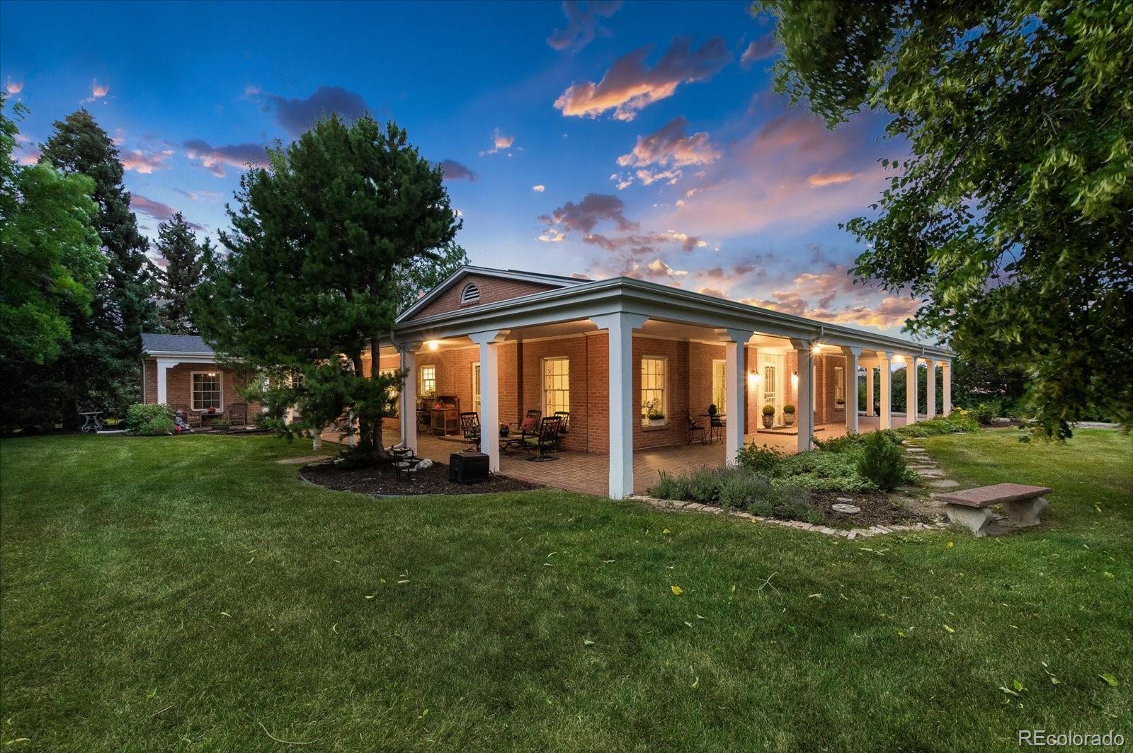 5225 Ridge Trail Bow Mar, CO 80123 - Photo 3 of 40 a view of a house with a big yard and large trees