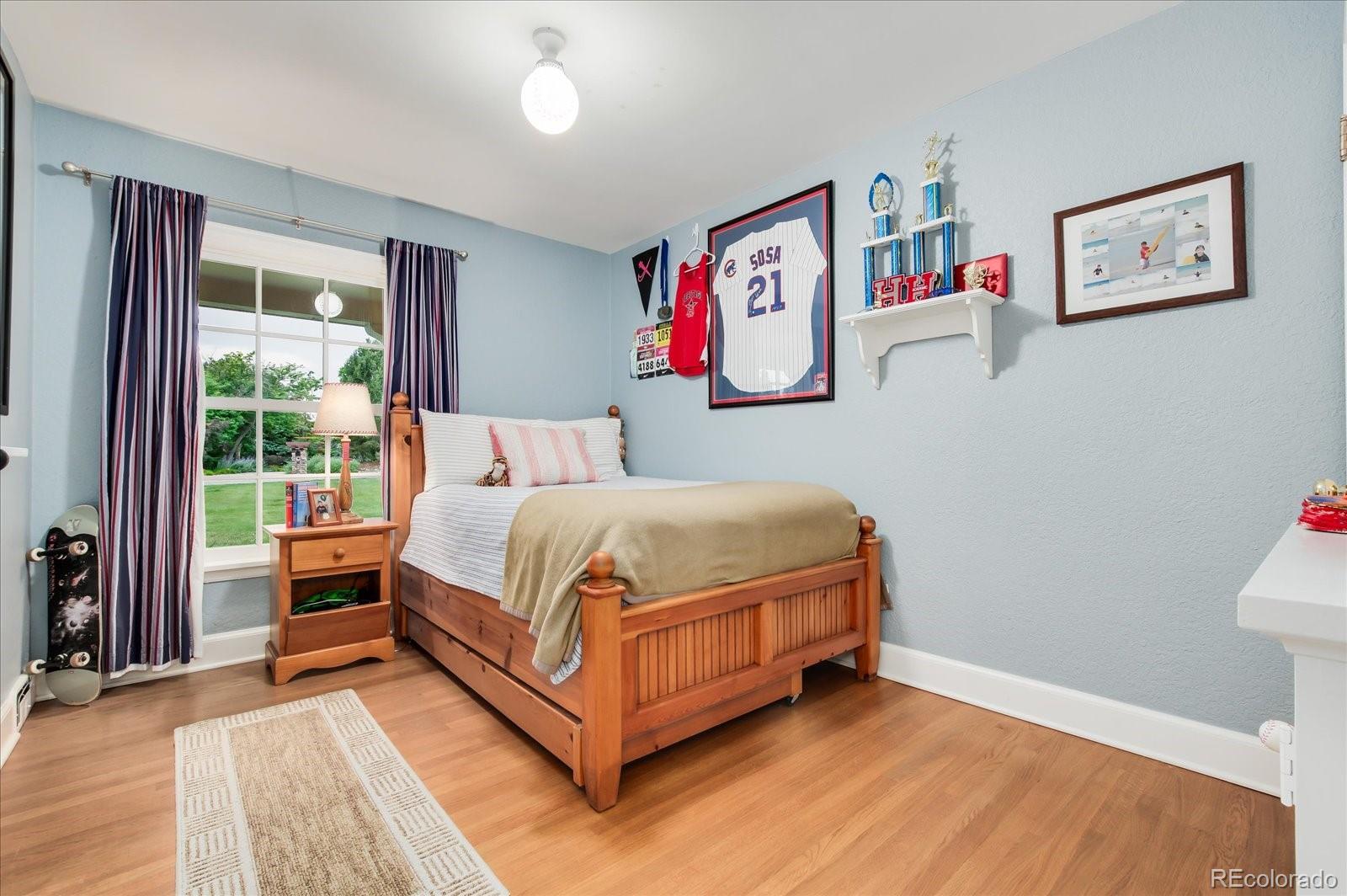 5225 Ridge Trail Bow Mar, CO 80123 - Photo 34 of 40 a bedroom with a bed and a window