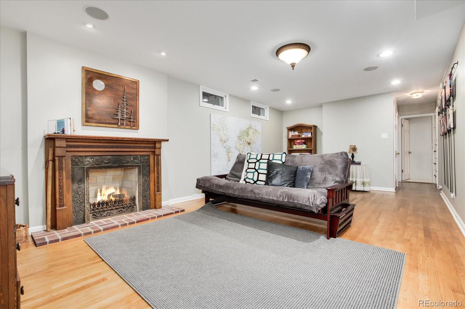 5225 Ridge Trail Bow Mar, CO 80123 - Photo 35 of 40 a living room with furniture and a fireplace