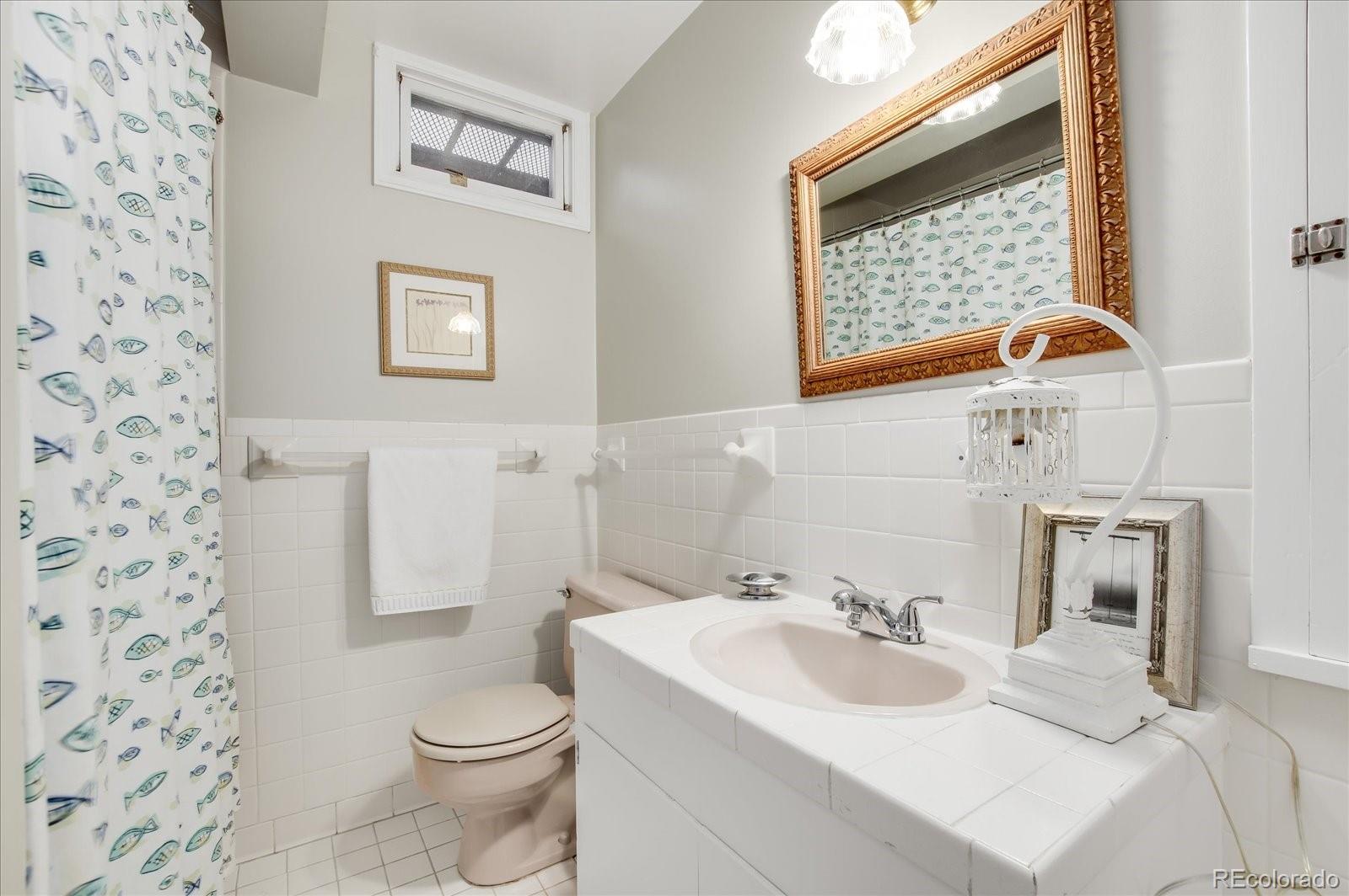 5225 Ridge Trail Bow Mar, CO 80123 - Photo 37 of 40 a bathroom with a sink toilet and shower