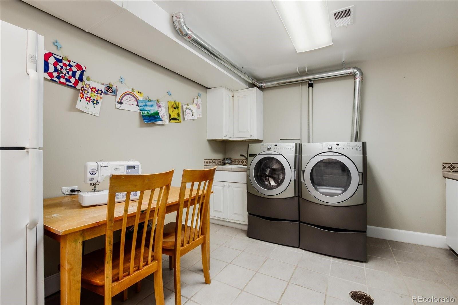 5225 Ridge Trail Bow Mar, CO 80123 - Photo 38 of 40 a utility room with a refrigerator and washer