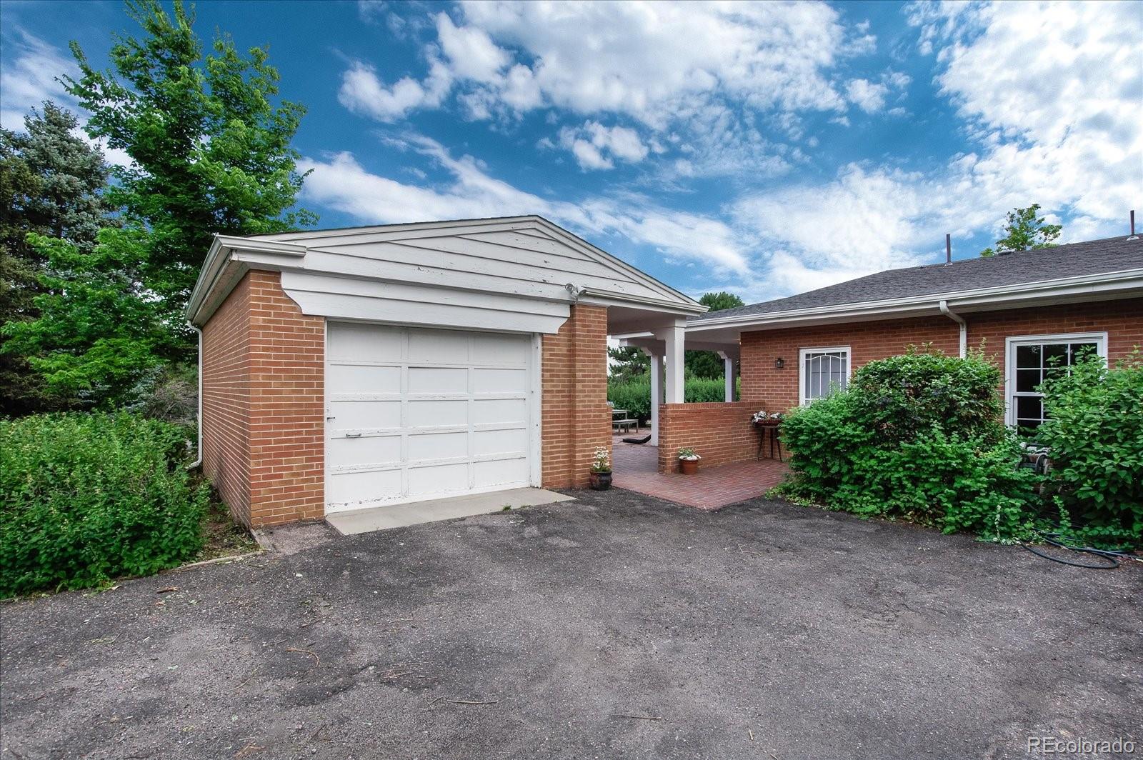 5225 Ridge Trail Bow Mar, CO 80123 - Photo 39 of 40 a view of house with garage and yard