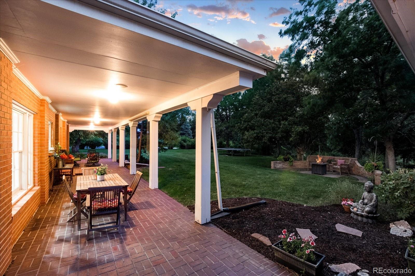 5225 Ridge Trail Bow Mar, CO 80123 - Photo 5 of 40 a patio with yard glass top table and chairs