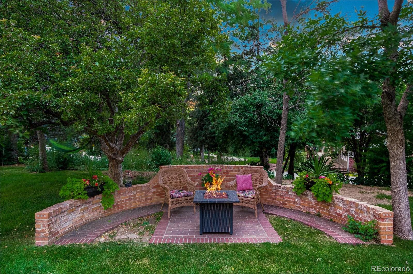 5225 Ridge Trail Bow Mar, CO 80123 - Photo 6 of 40 a view of a wooden deck with chairs and a yard