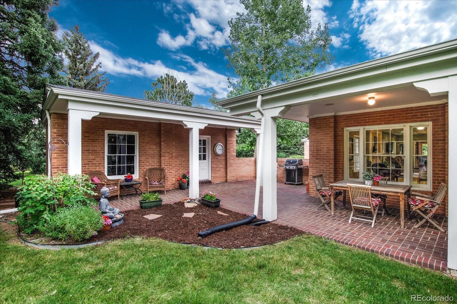 5225 Ridge Trail Bow Mar, CO 80123 - Photo 9 of 40 a view of a house with backyard sitting area and garden