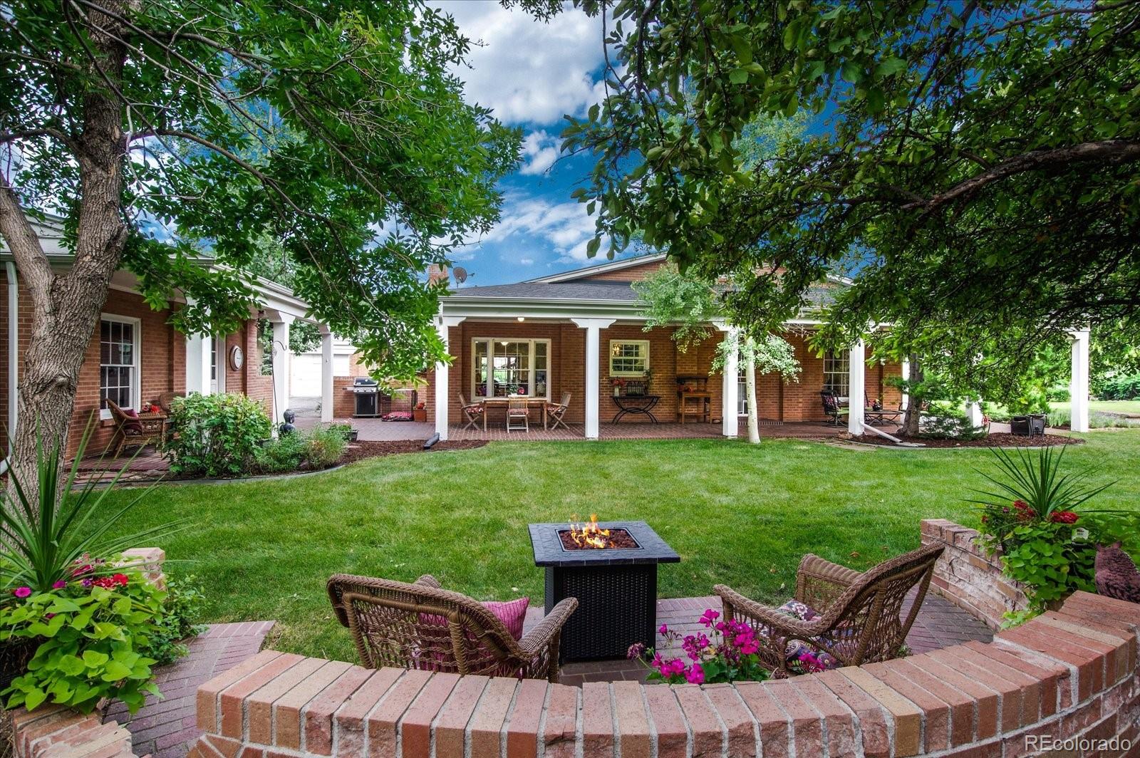 5225 Ridge Trail Bow Mar, CO 80123 - Photo 10 of 40 a view of a house with backyard sitting area and garden