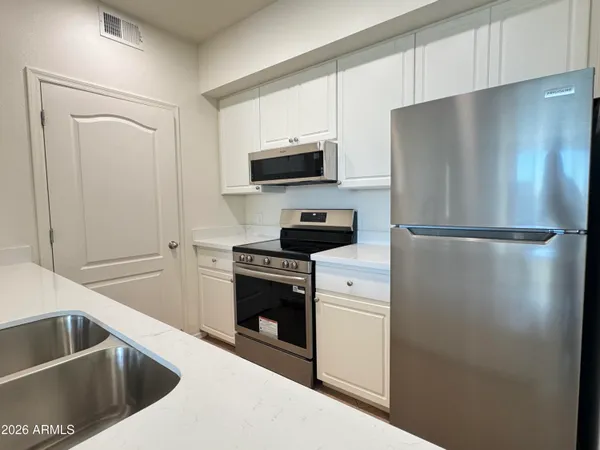 a kitchen with a refrigerator stove and microwave