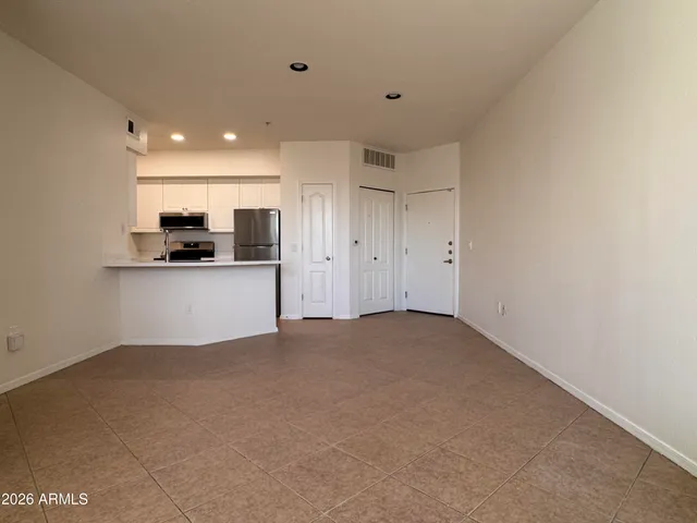 a view of a kitchen with a sink and a refrigerator