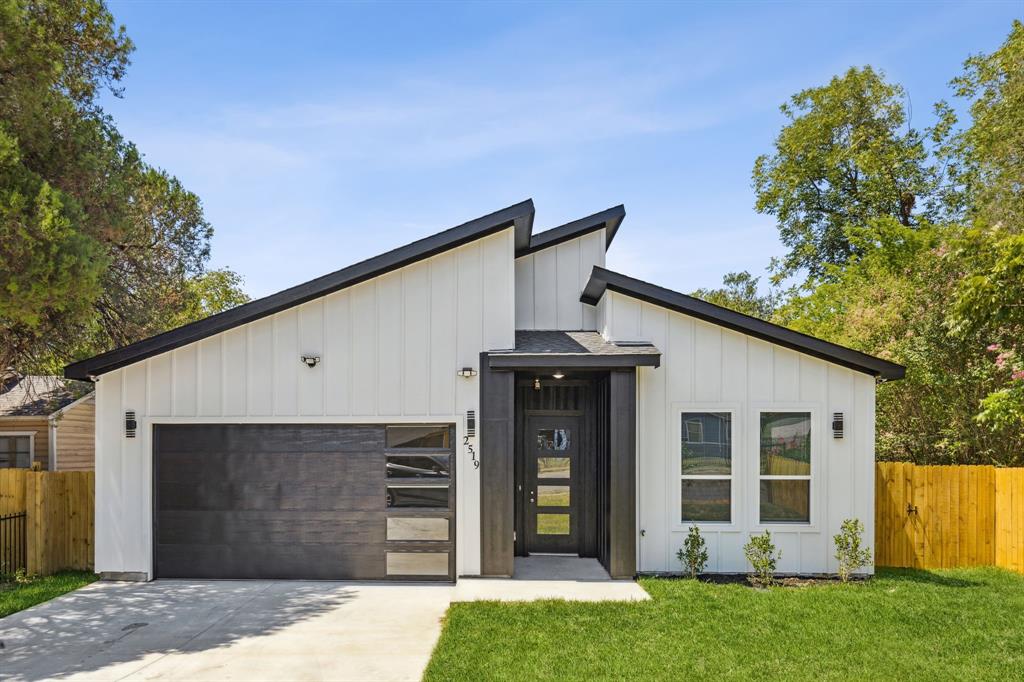 a front view of a house with a garden and plants