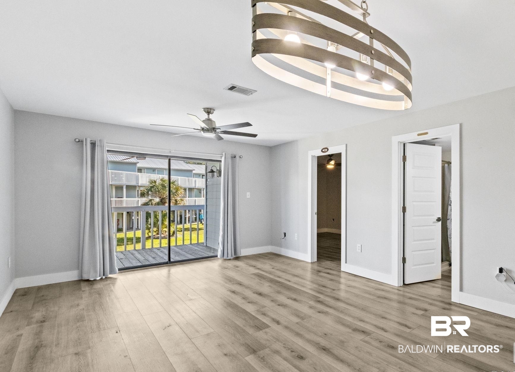 25861 Canal Road, Unit 77 Orange Beach, AL 36561 - Photo 18 of 48 Empty room featuring light wood-style floors and baseboards