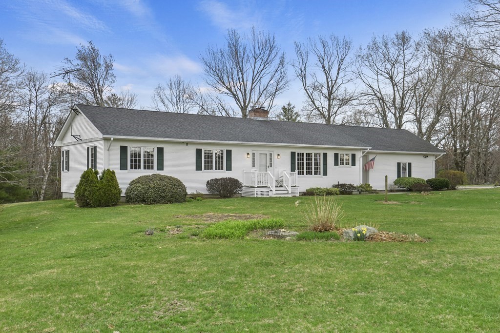 1007 Spring Hill Road Barre, MA 01005 - Photo 1 of 39 a view of a house with a big yard with plants and large tree