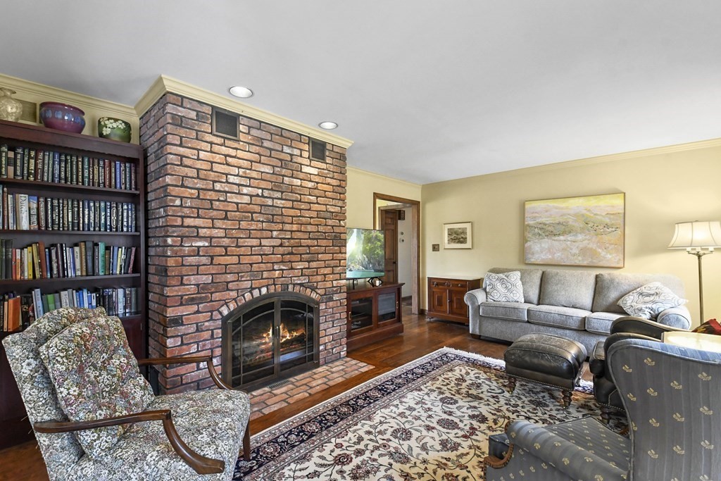 1007 Spring Hill Road Barre, MA 01005 - Photo 16 of 39 a living room with furniture a rug a fireplace and a book shelf