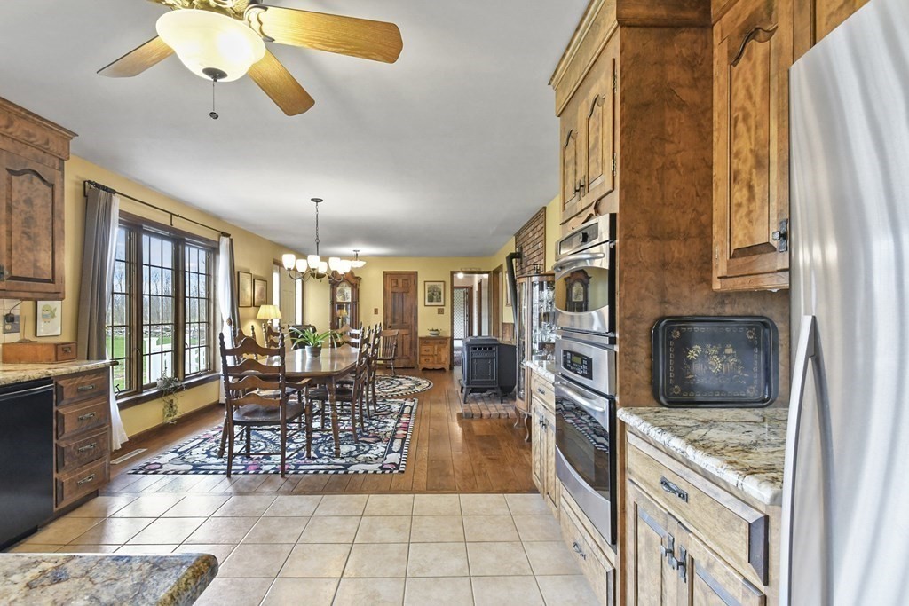 1007 Spring Hill Road Barre, MA 01005 - Photo 10 of 39 a kitchen with stainless steel appliances granite countertop a stove top oven a sink and cabinets