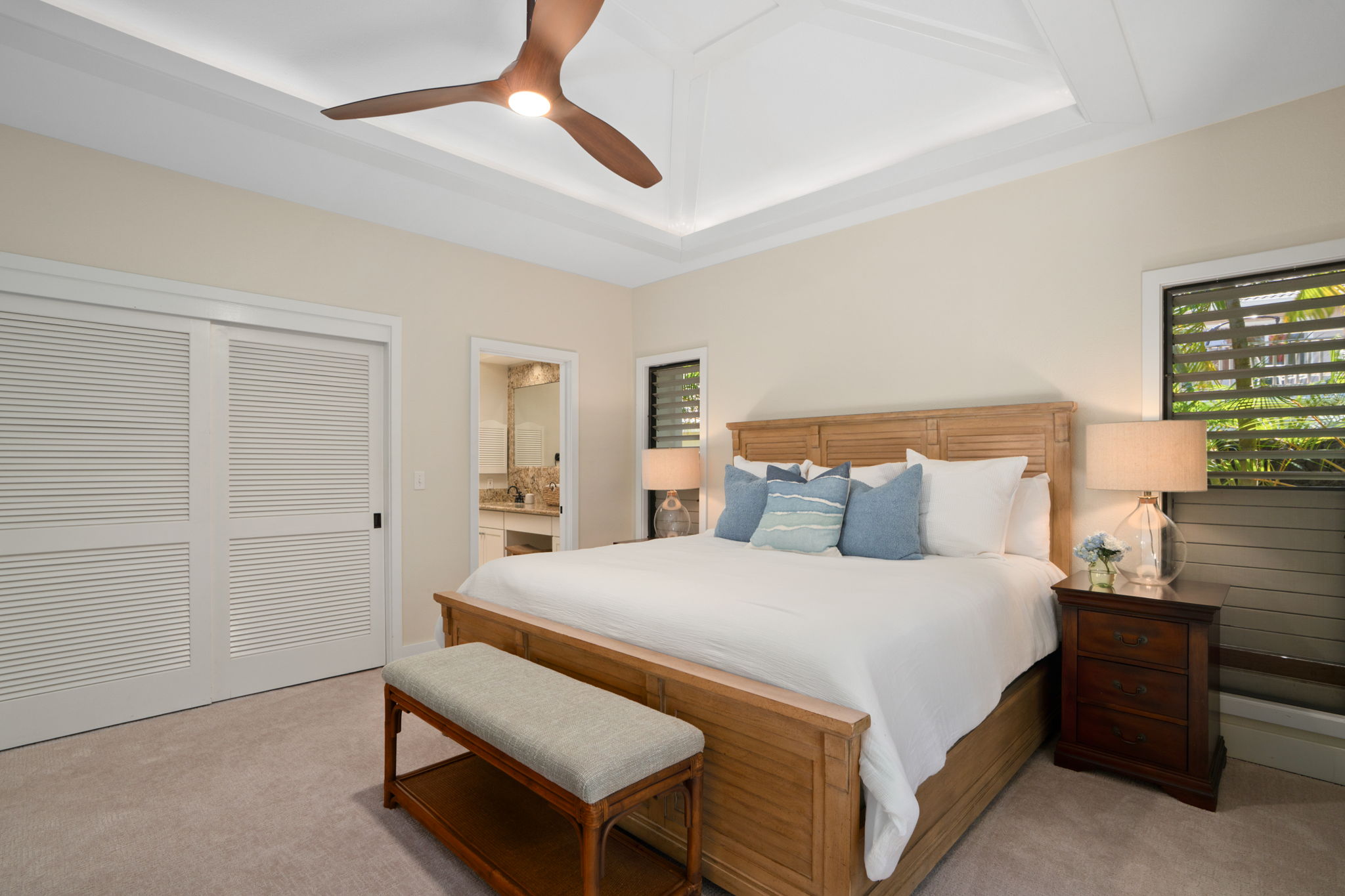 1753 Kelaukia Street Koloa, HI 96756 - Photo 18 of 27 a bedroom with a bed and a chandelier fan
