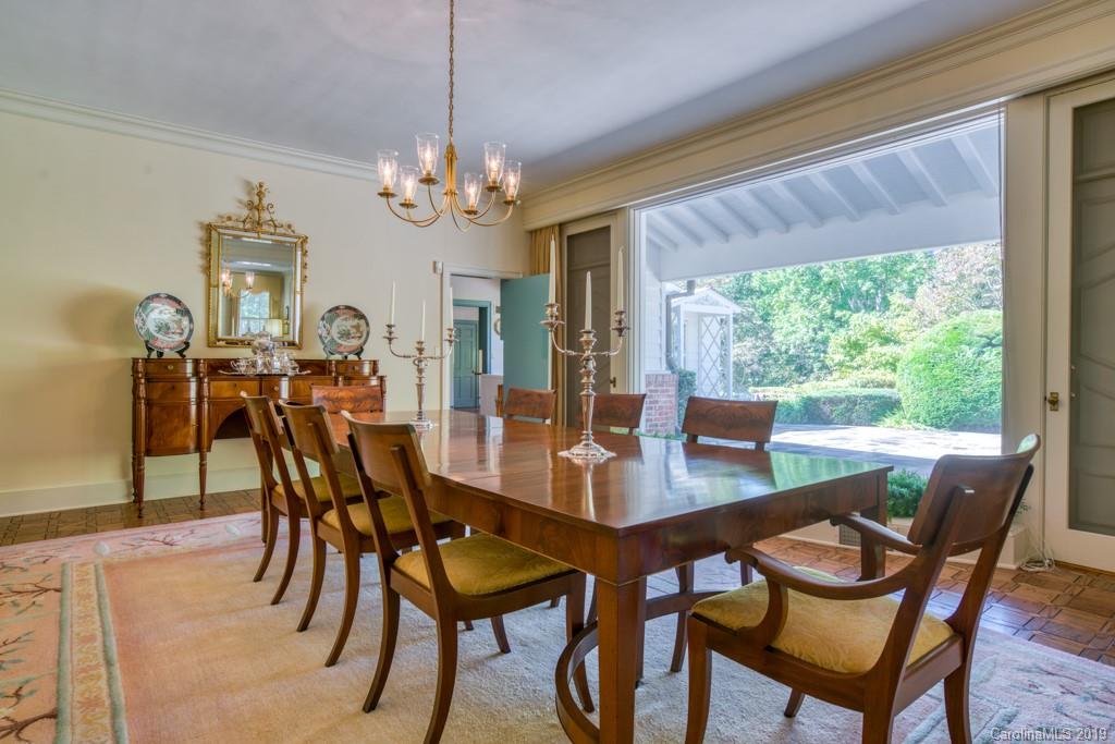 355 Mimosa Road Tryon, NC 28782 - Photo 22 of 44 a view of a dining room with furniture window and wooden floor