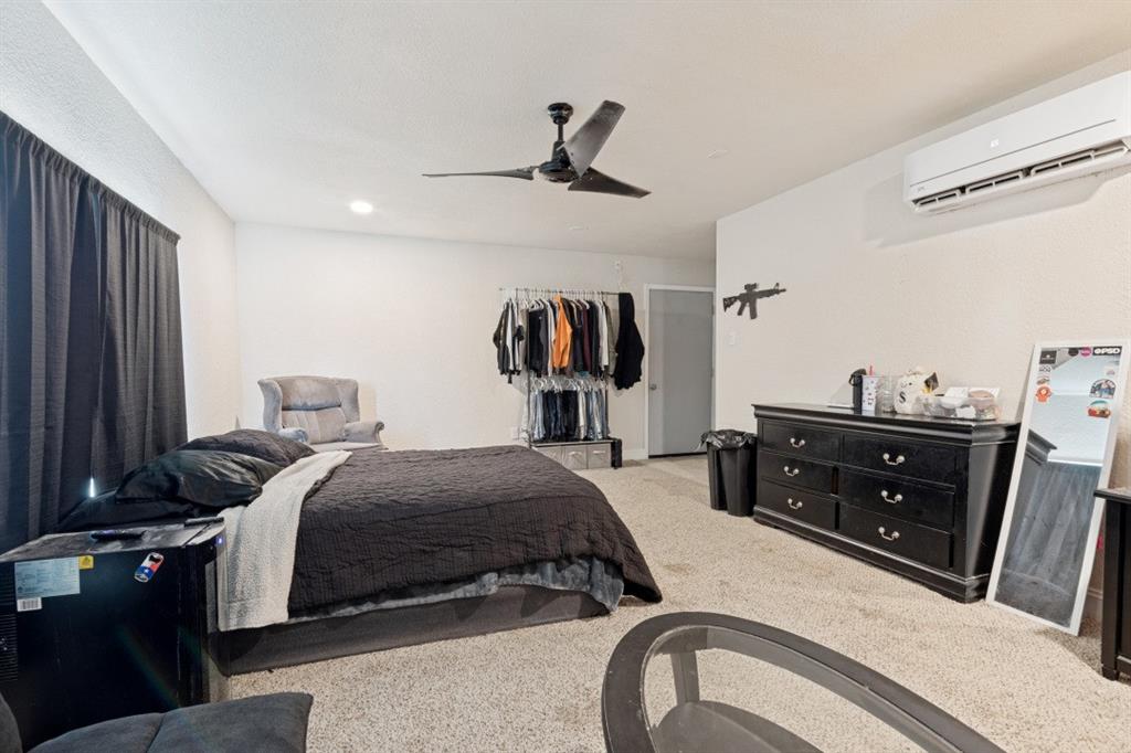 7410 Jessica Way Rowlett, TX 75088 - Photo 15 of 25 a bedroom with a bed and a dresser
