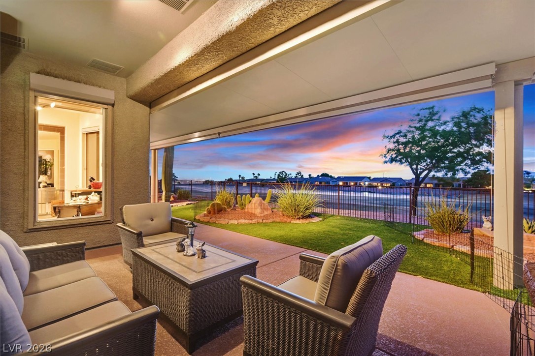 1823 Baton Rouge Street Henderson, NV 89052 - Photo 40 of 60 A spacious covered patio looks out over a manicured lawn toward sunset views.