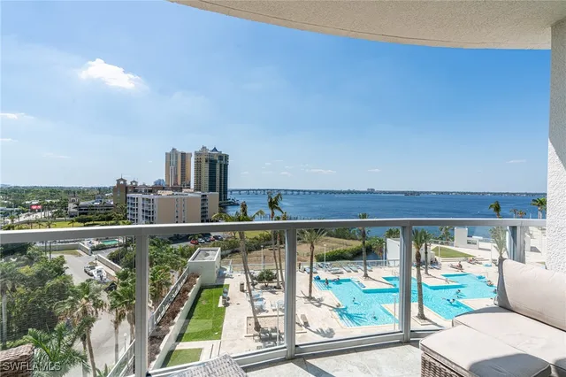 a view of a balcony with lake view and wooden floor