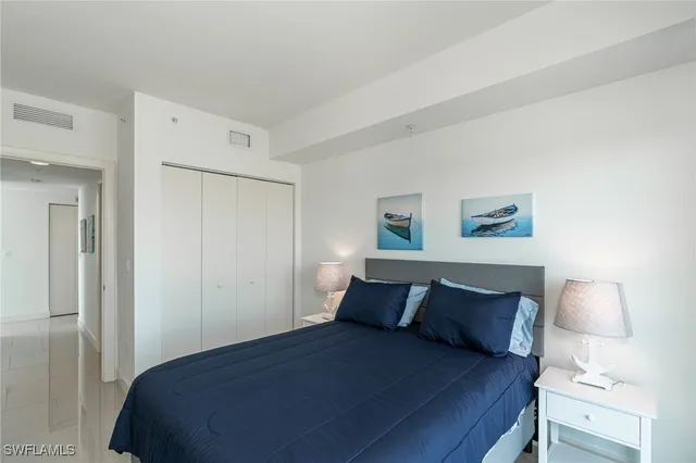 a bedroom with a bed and a night stand