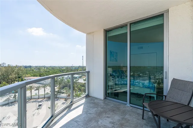 a balcony with chairs and a table