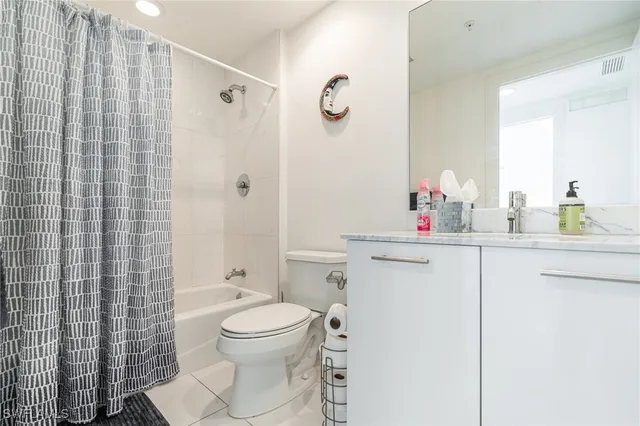 a bathroom with a toilet sink vanity and shower