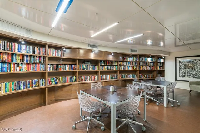 a dining room with lots of furniture and a bookshelf