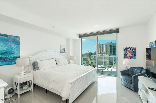 a bedroom with a bed and a large window with outer view