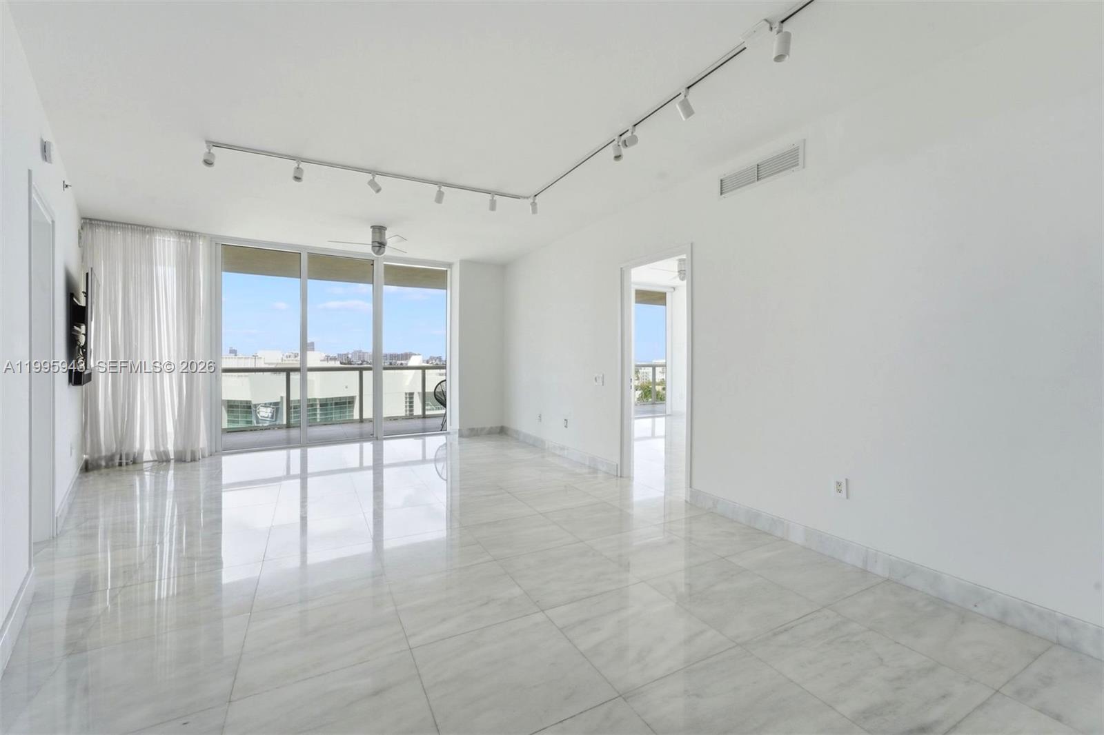 450 Alton Road, Unit 910 Miami Beach, FL 33139 - Photo 25 of 59 a view of empty room with kitchen and window