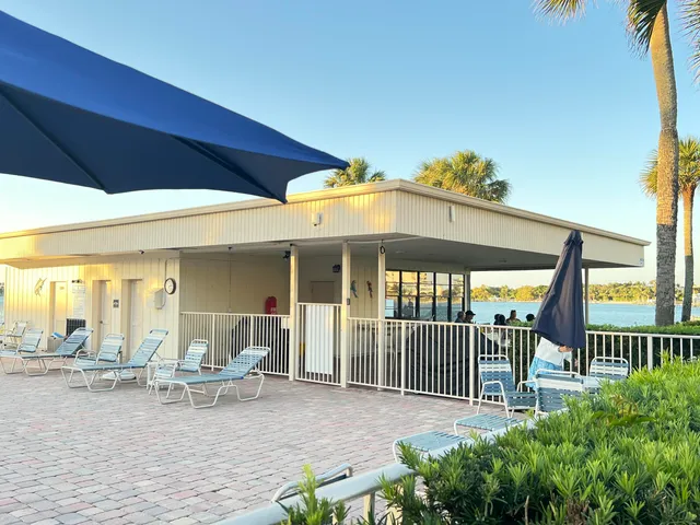 a front view of a house with a yard and potted plants