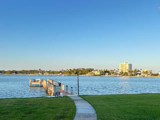 a wooden bench sitting next to a lake