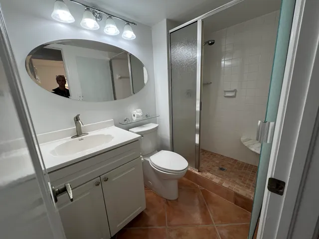 a bathroom with a sink toilet and shower