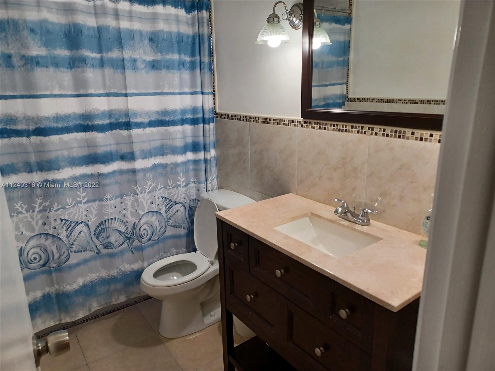 Andover Lakes Miami Gardens, FL 33179 - Photo 15 of 41 a bathroom with a sink toilet and shower
