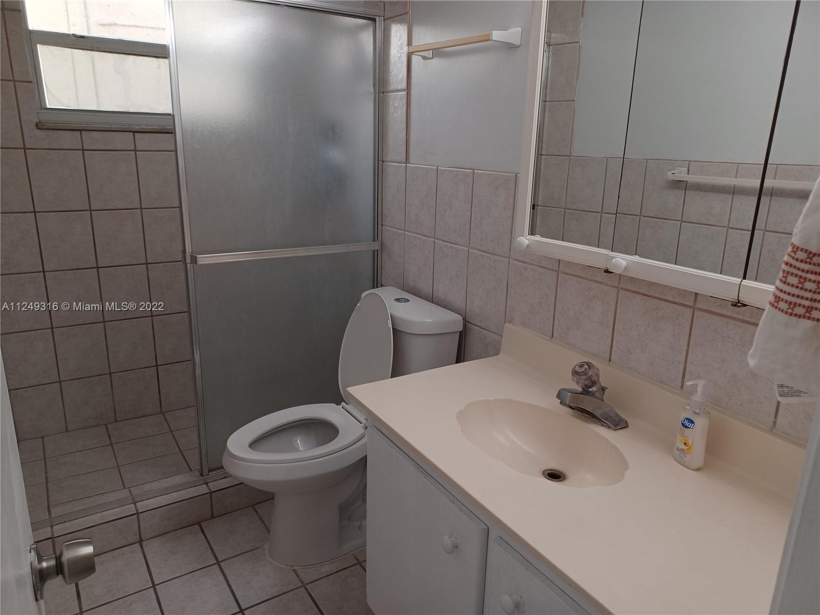 Andover Lakes Miami Gardens, FL 33179 - Photo 17 of 41 a bathroom with a sink toilet and shower