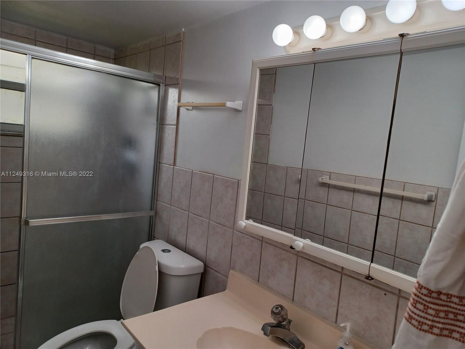 Andover Lakes Miami Gardens, FL 33179 - Photo 18 of 41 a bathroom with a toilet and a shower