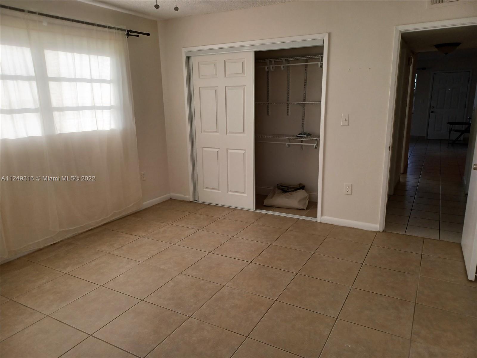 Andover Lakes Miami Gardens, FL 33179 - Photo 20 of 41 an empty room with windows