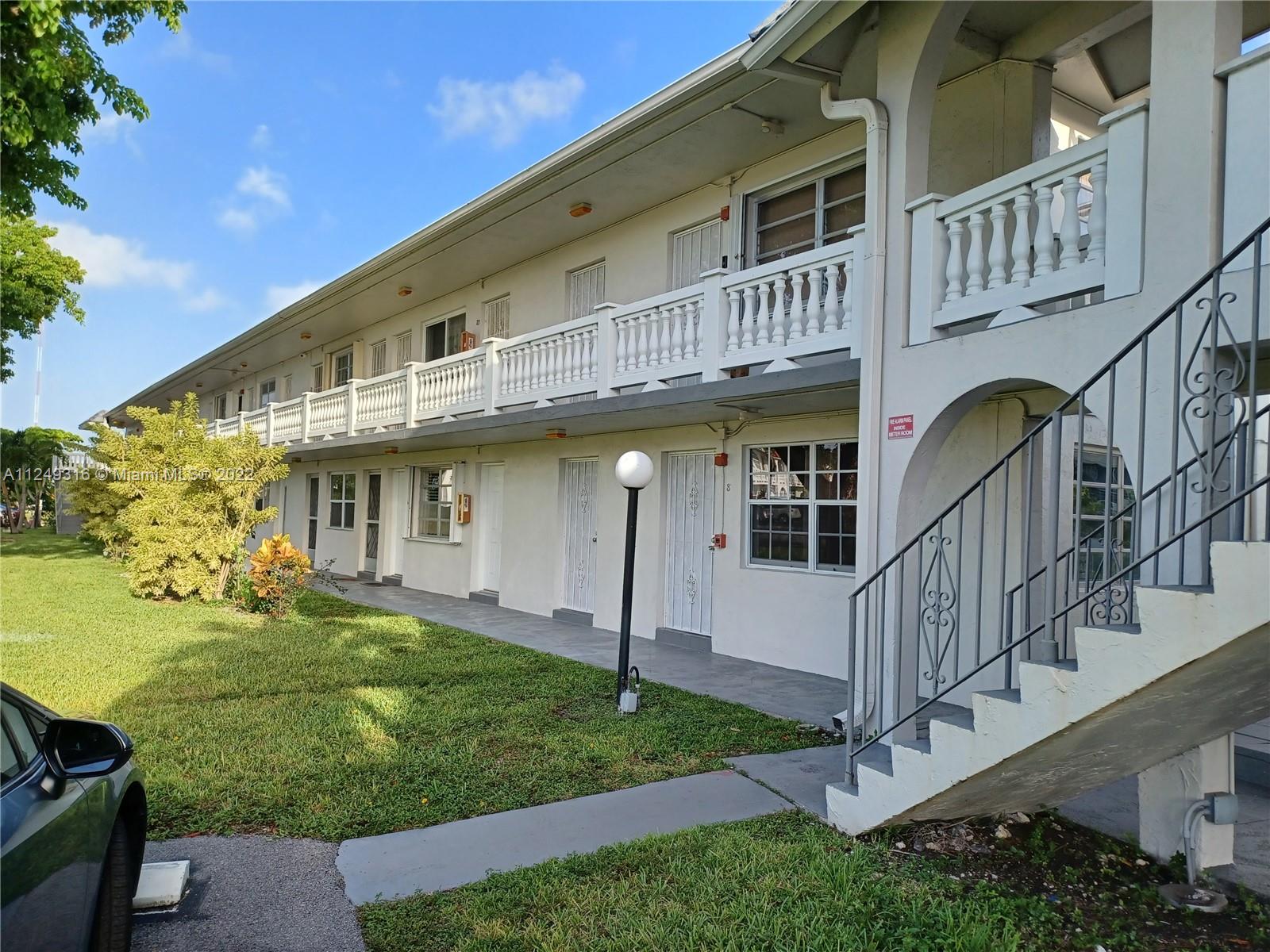 Andover Lakes Miami Gardens, FL 33179 - Photo 2 of 41 a view of a house with brick walls and a yard with potted plants