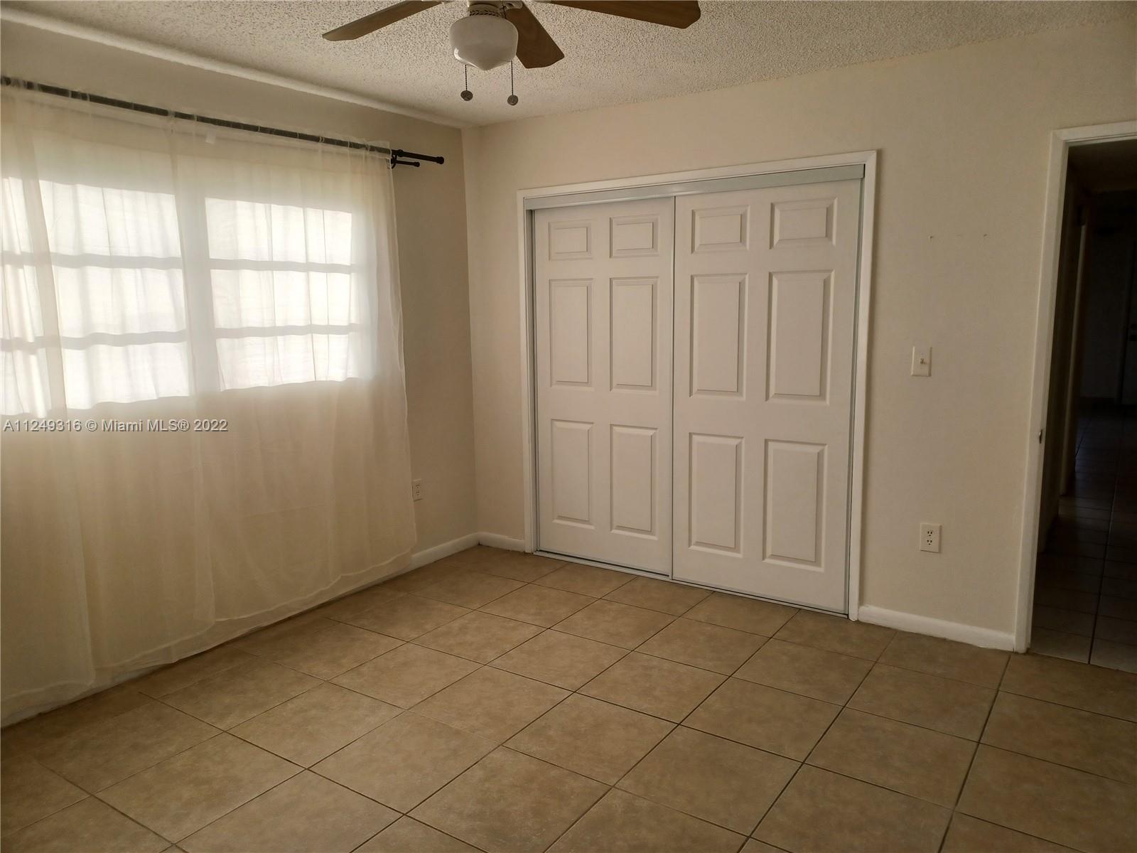Andover Lakes Miami Gardens, FL 33179 - Photo 21 of 41 an empty room with windows