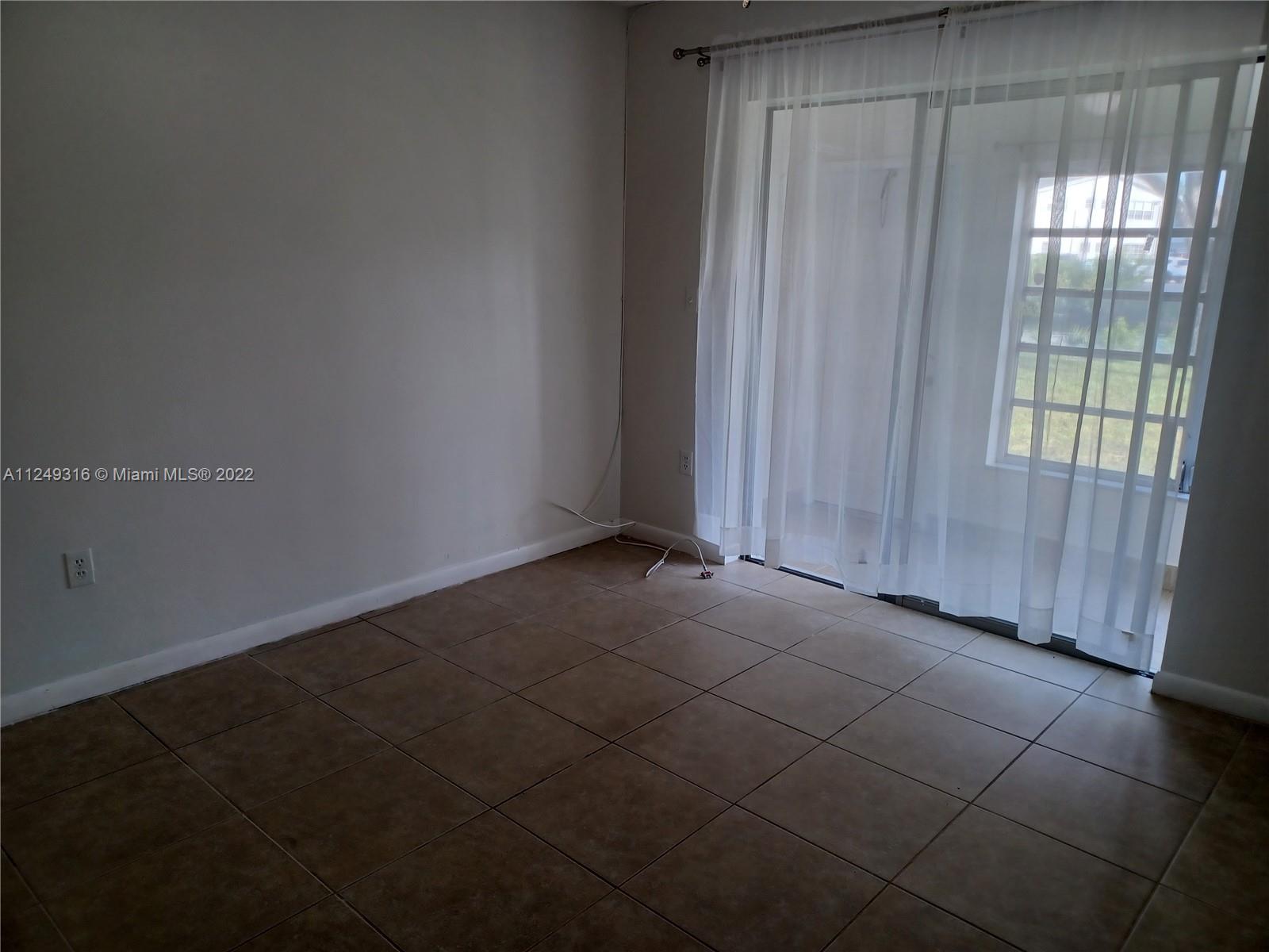 Andover Lakes Miami Gardens, FL 33179 - Photo 23 of 41 a view of an empty room with a window