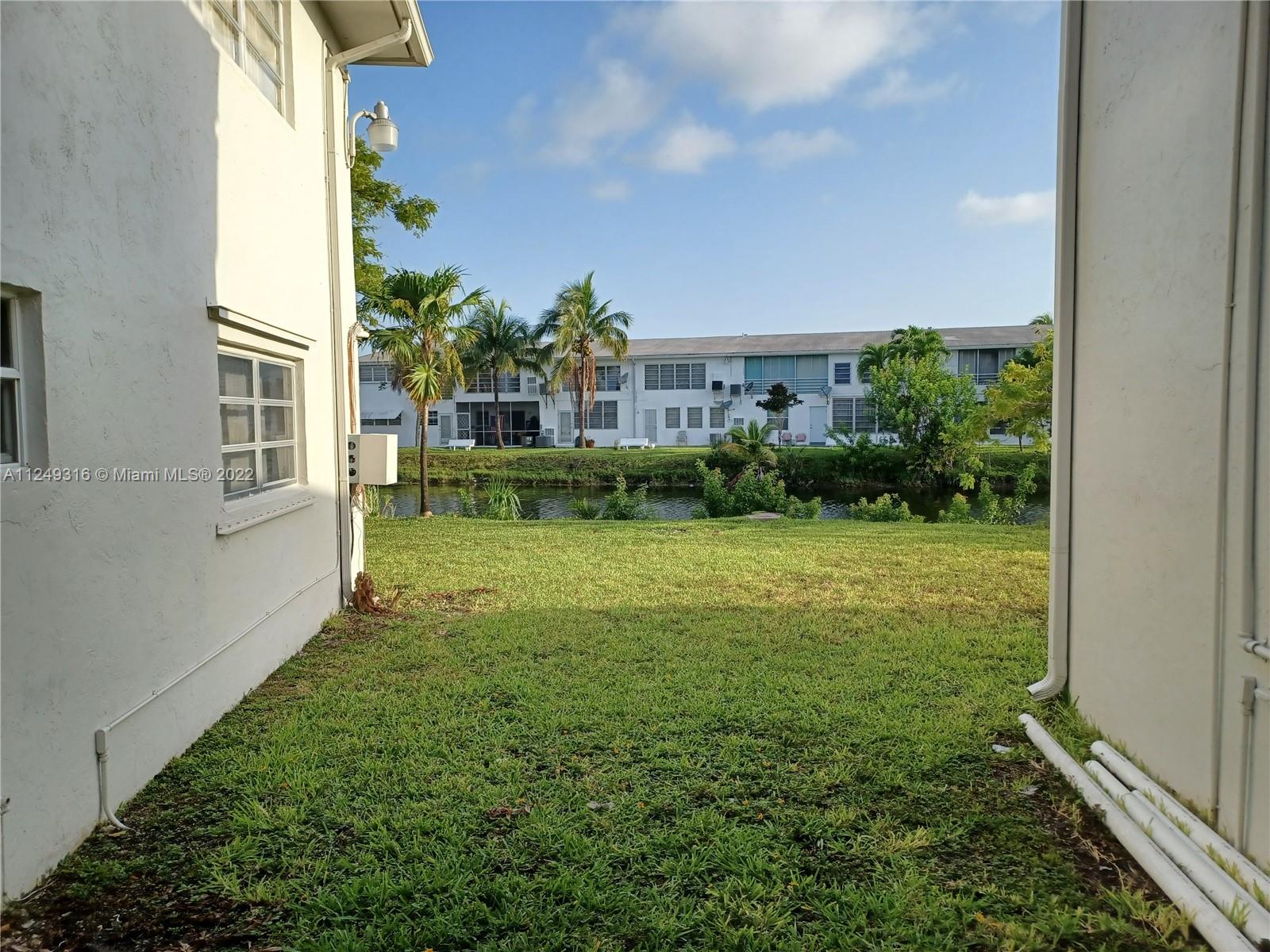 Andover Lakes Miami Gardens, FL 33179 - Photo 3 of 41 a view of a yard in front of a house