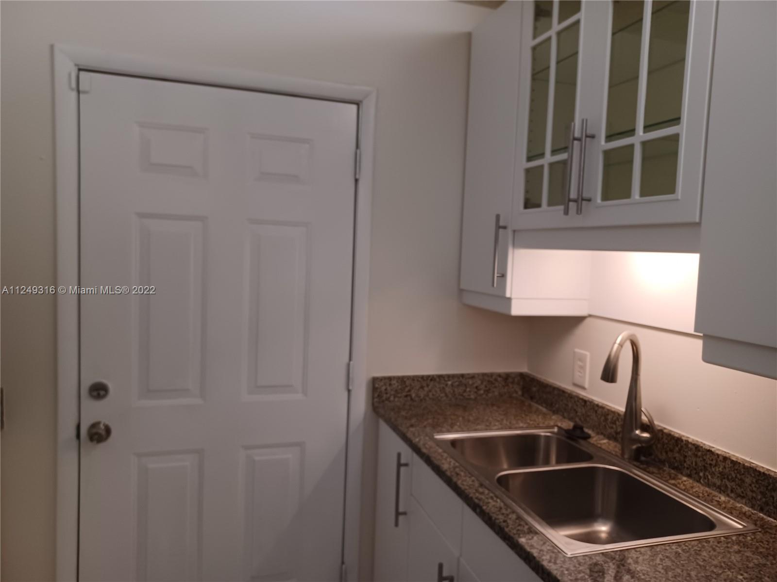 Andover Lakes Miami Gardens, FL 33179 - Photo 34 of 41 a kitchen with a sink and cabinets