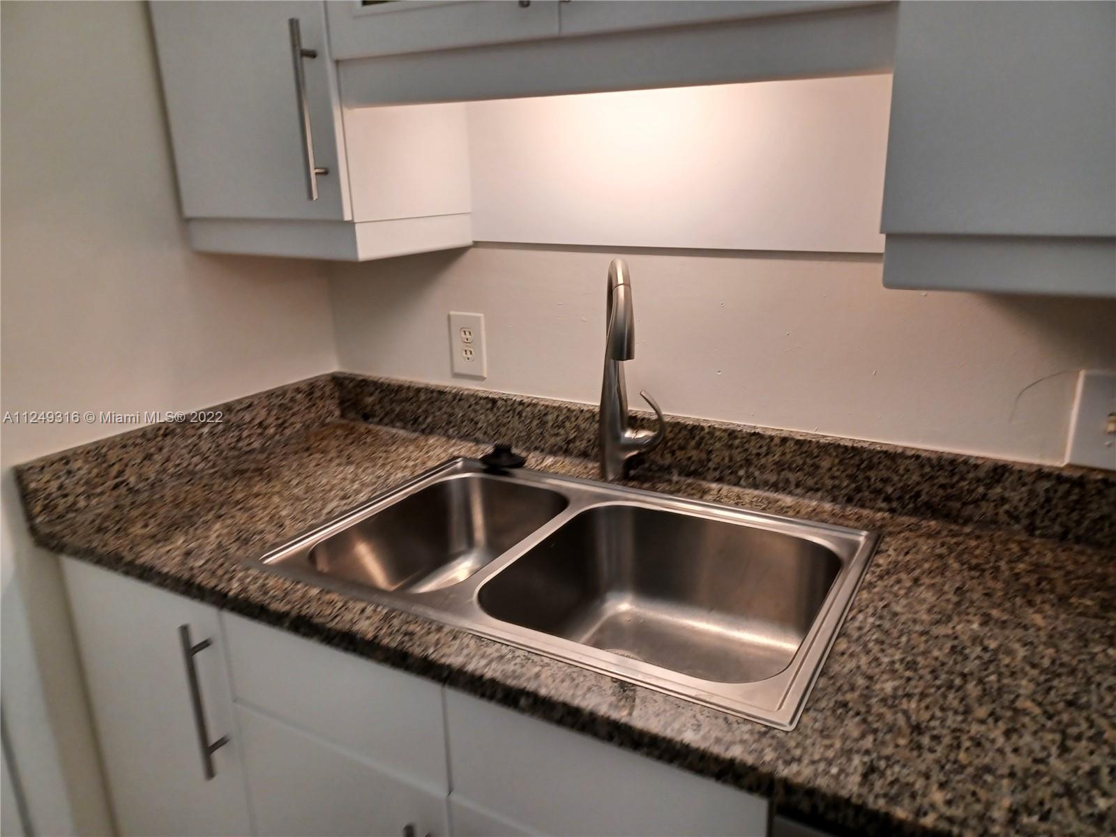 Andover Lakes Miami Gardens, FL 33179 - Photo 35 of 41 a kitchen with a sink and a granite counter top