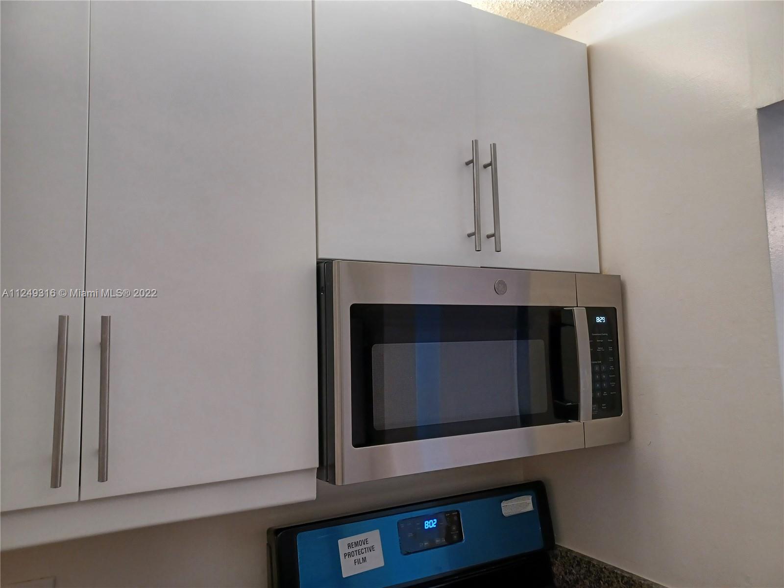 Andover Lakes Miami Gardens, FL 33179 - Photo 38 of 41 a living room with a fireplace