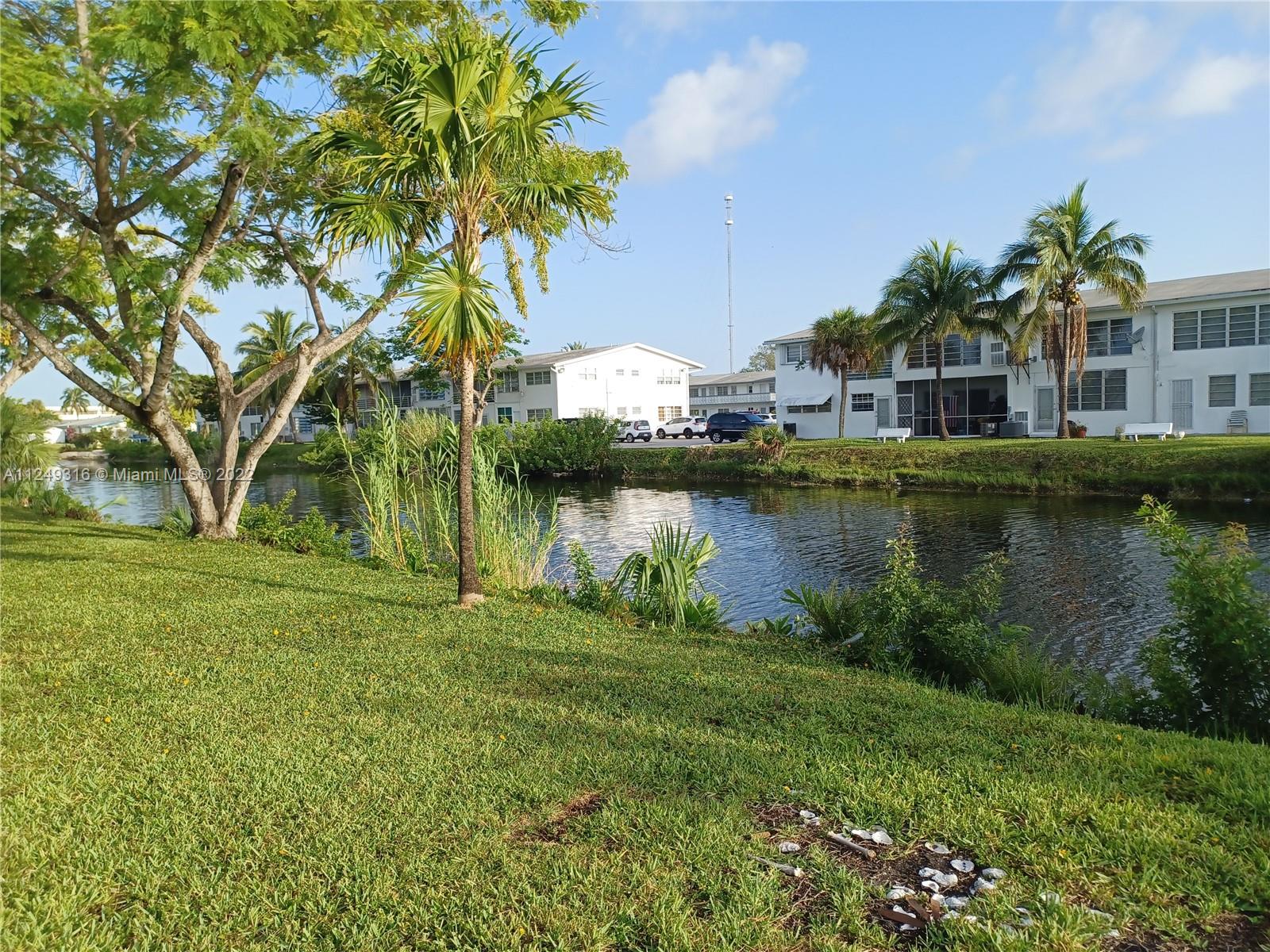 Andover Lakes Miami Gardens, FL 33179 - Photo 6 of 41 a view of a lake with a house in the background