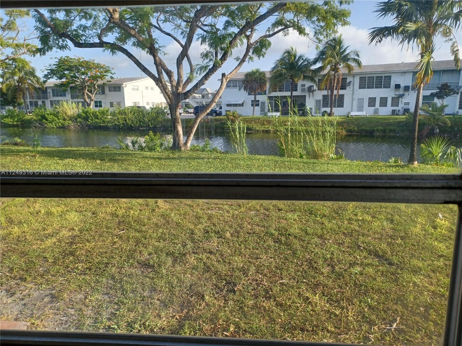 Andover Lakes Miami Gardens, FL 33179 - Photo 8 of 41 a front view of a house with a yard