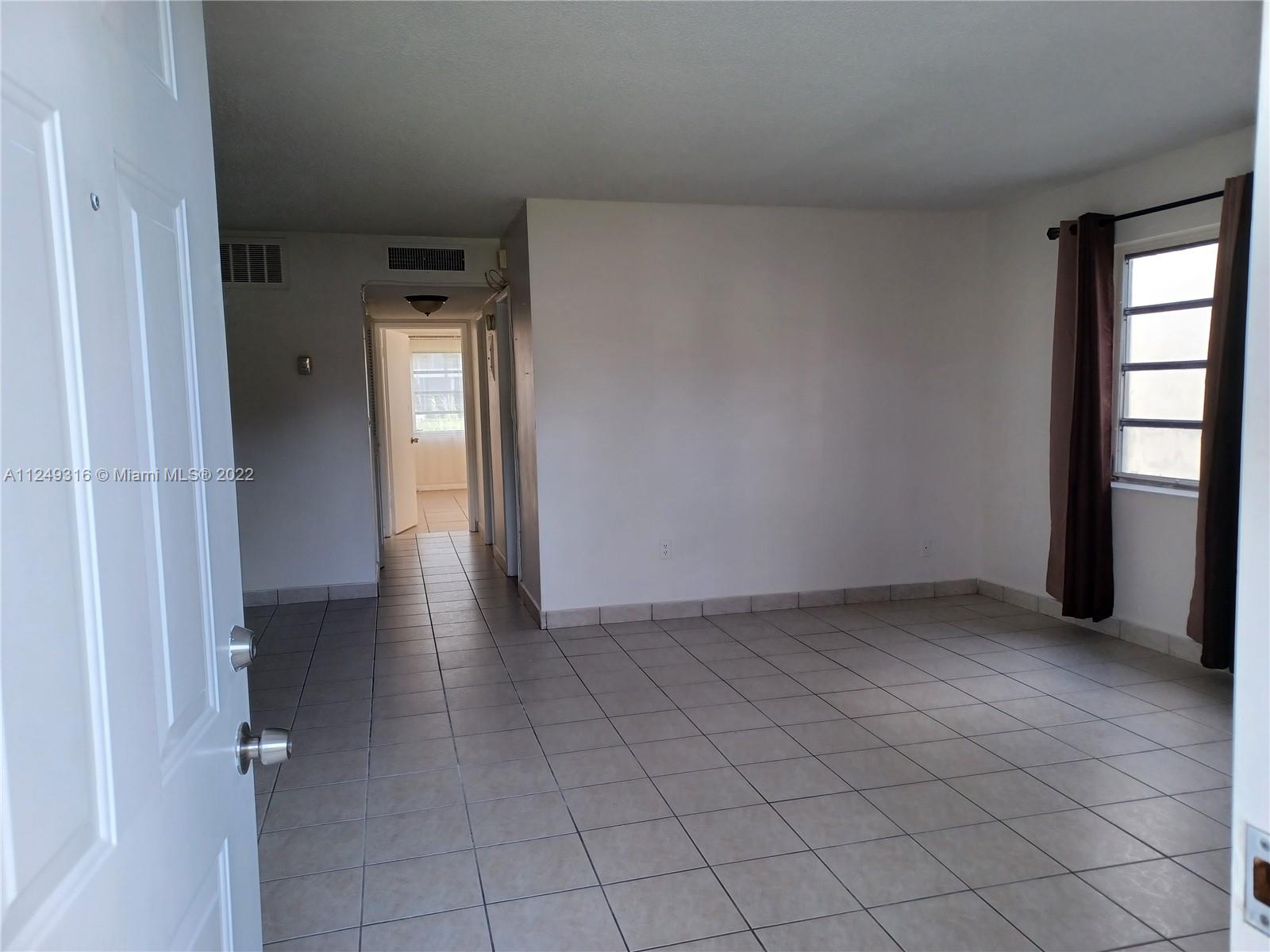 Andover Lakes Miami Gardens, FL 33179 - Photo 9 of 41 an empty room with windows