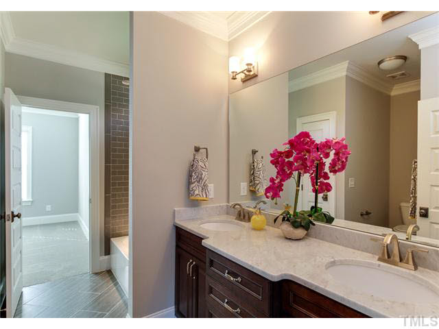 9238 Carlswood Court Raleigh, NC 27613 - Photo 14 of 24 Designer Style And Details. Dual Vanity And Plenty Of Storage. Soft Close Drawers And Doors. Custom Tile And Upgraded Lighting. Linen Closet And Private Access From Bedrooms.