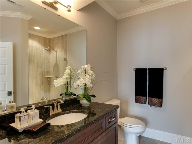9238 Carlswood Court Raleigh, NC 27613 - Photo 22 of 24 Beautiful Bathroom On The Second Floor. Granite Counters And Custom Tile Design In The Shower.