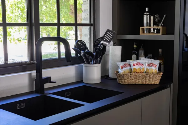 a kitchen with a sink appliances and cabinets