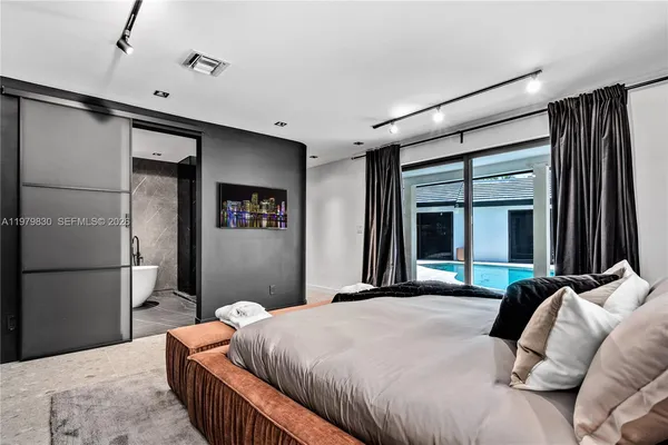 a view of hotel room with a large window and chandelier